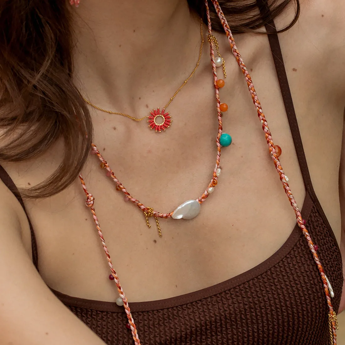 Braided necklace with natural pearls and gemstones